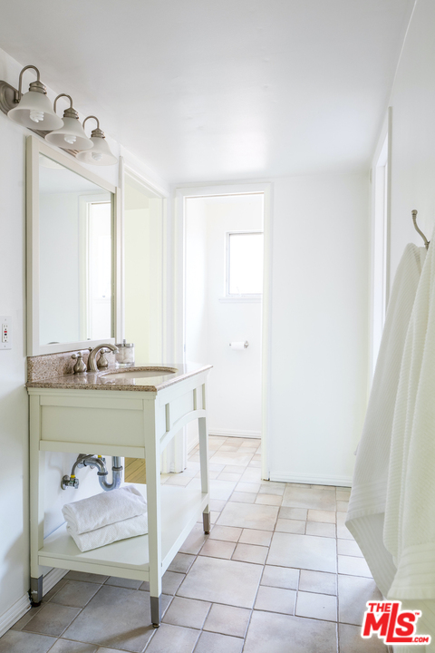 348 Sycamore Road Santa Monica, CA 90402 - Photo 11 of 12 a bathroom with a sink a vanity and a mirror