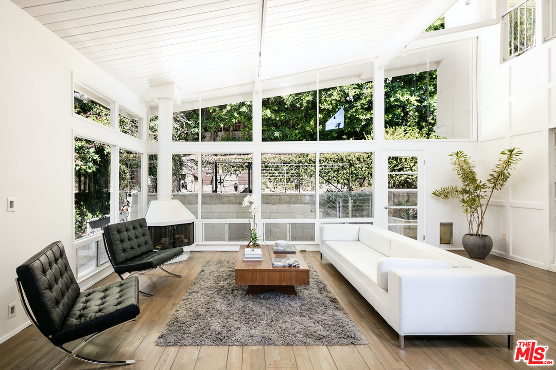 348 Sycamore Road Santa Monica, CA 90402 - Photo 3 of 12 a living room with furniture and a large window
