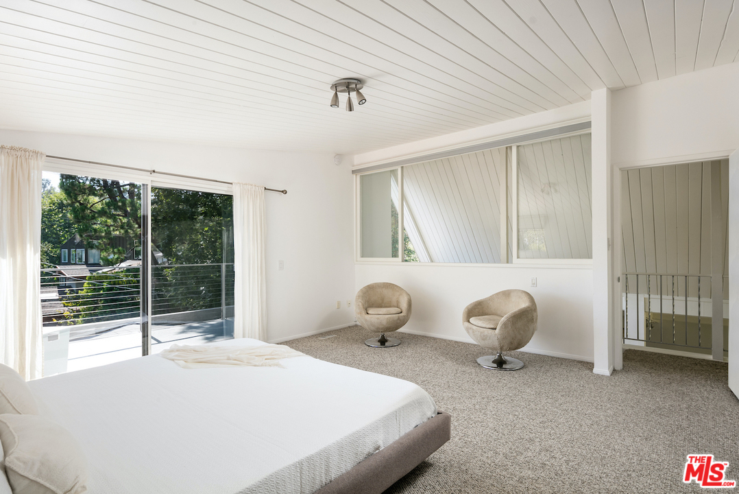 348 Sycamore Road Santa Monica, CA 90402 - Photo 8 of 12 a bedroom with a bed and large windows
