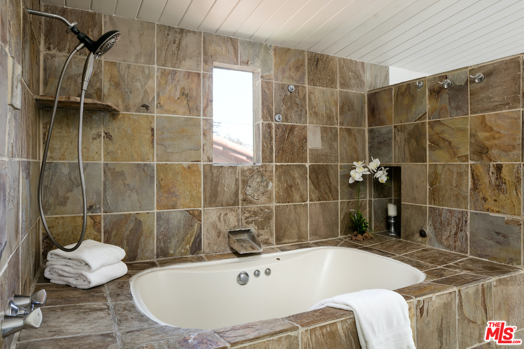 348 Sycamore Road Santa Monica, CA 90402 - Photo 9 of 12 a bathroom with a bathtub and shower