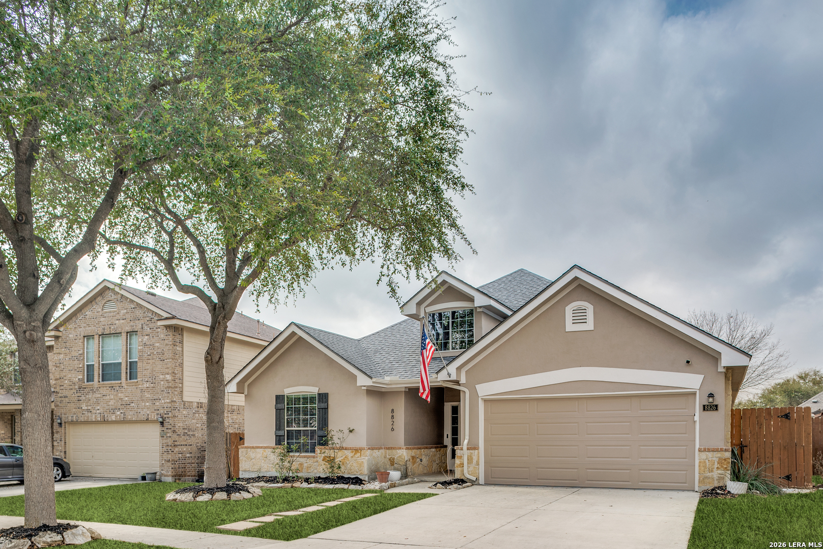 8826 Firebaugh Drive Helotes, TX 78023 - Photo 1 of 1 a view of a white house next to a yard with large trees