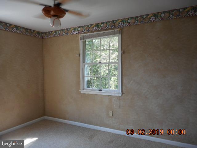 1520 Old Plum Point Road Huntingtown, MD 20639 - Photo 14 of 14 a view of a room with a window and a ceiling fan