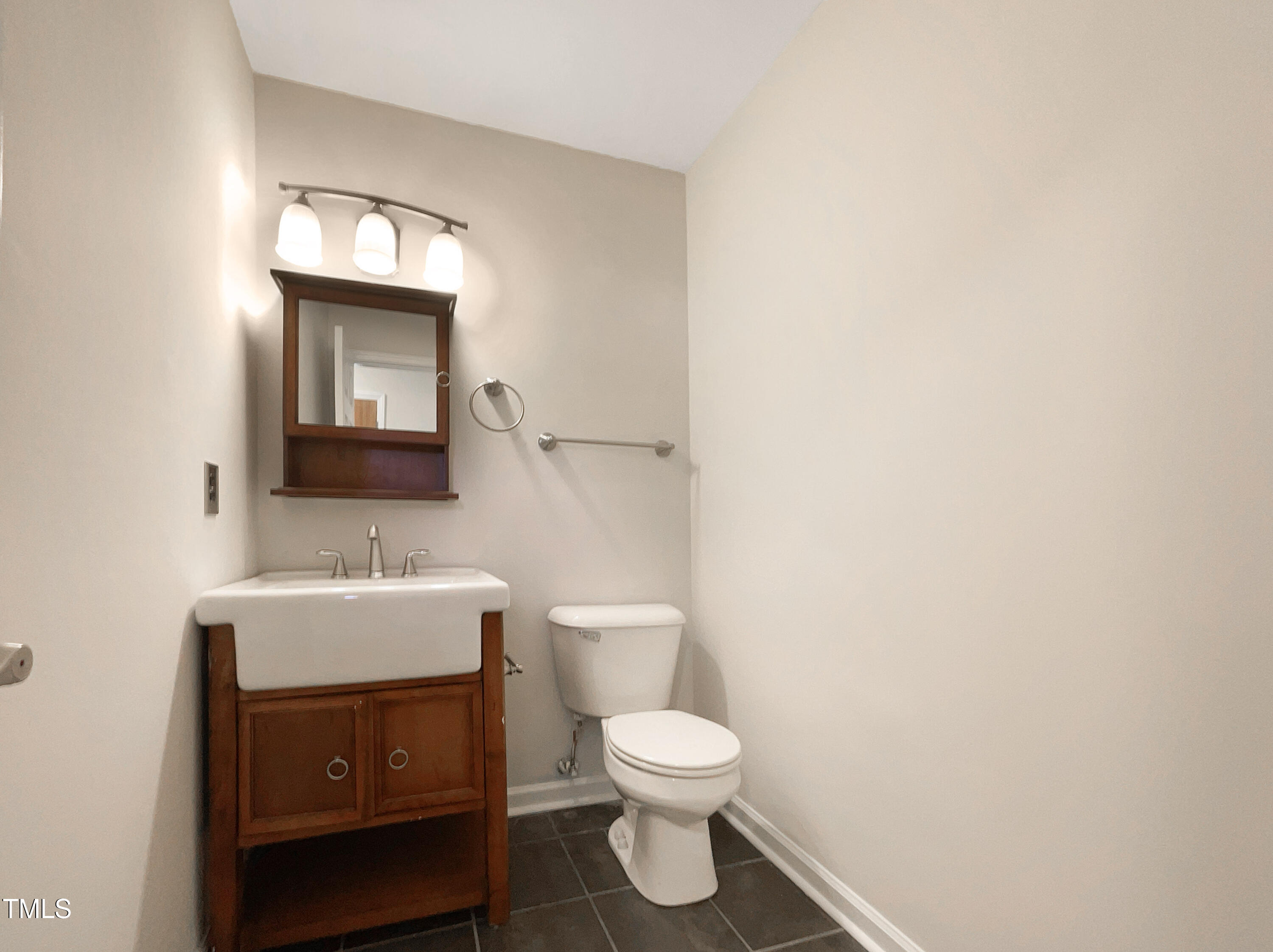 27 Pine Croft Road Angier, NC 27501 - Photo 11 of 19 a bathroom with a toilet a sink and mirror