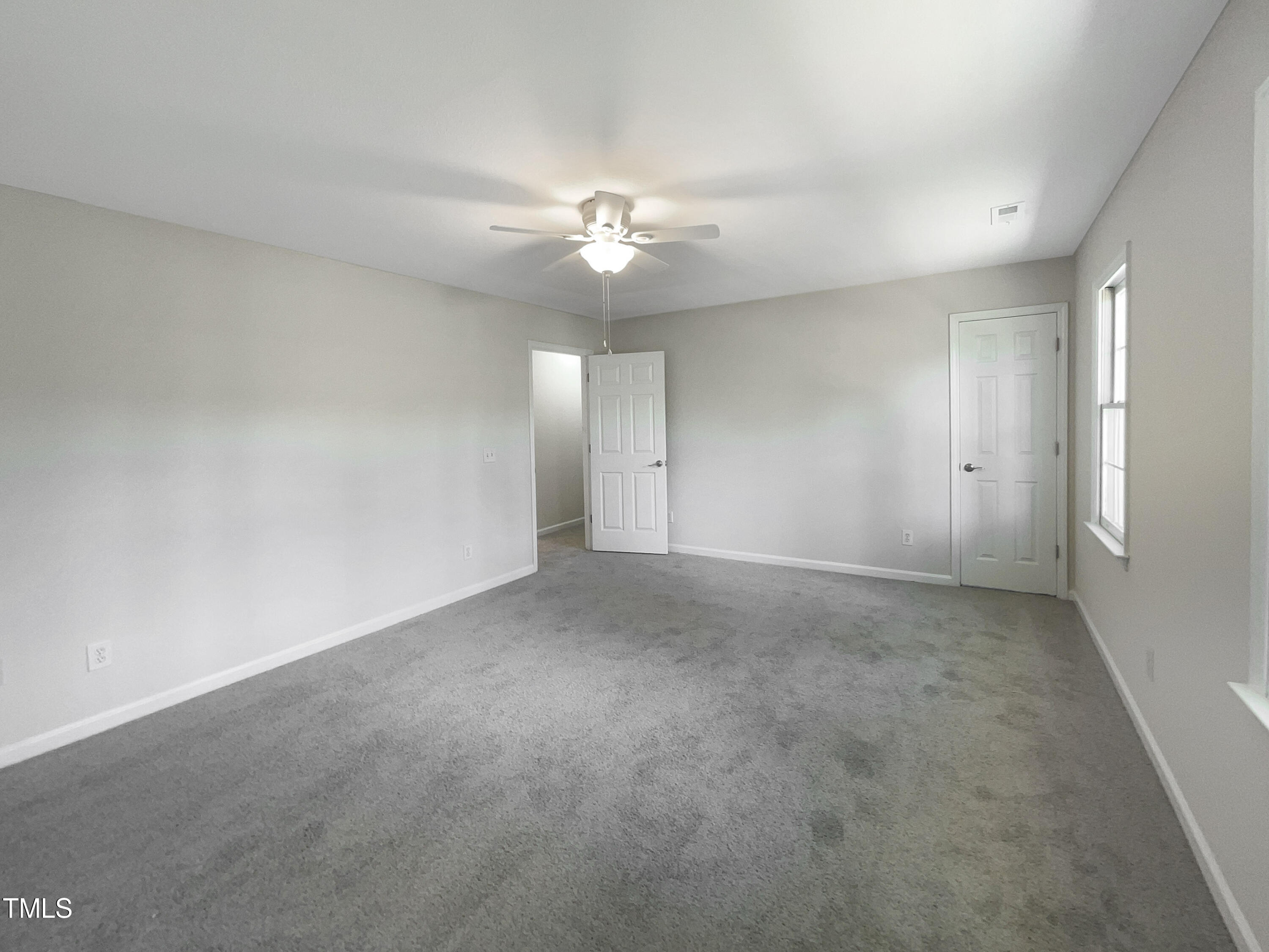 27 Pine Croft Road Angier, NC 27501 - Photo 14 of 19 an empty room with chandelier fan and windows