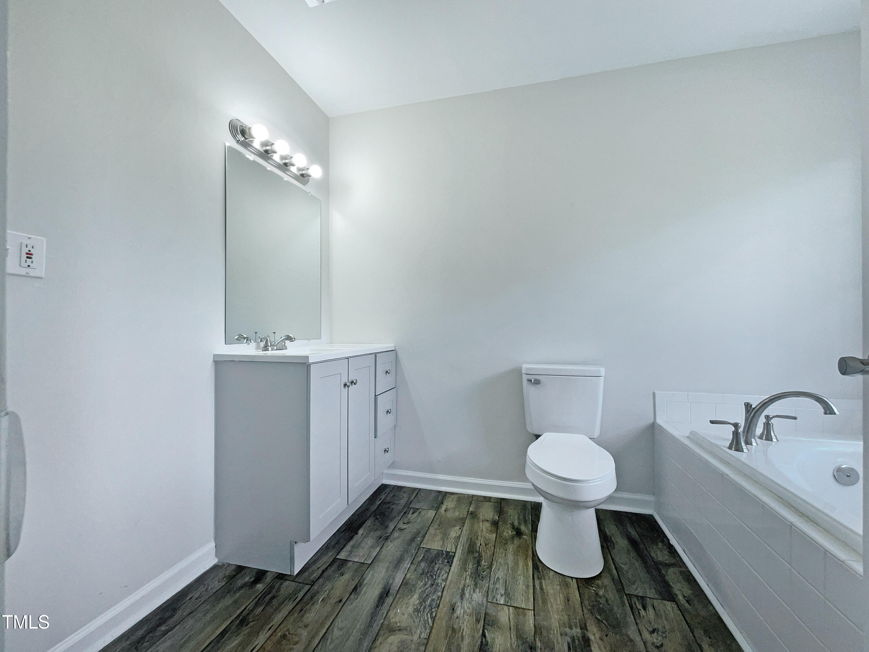 27 Pine Croft Road Angier, NC 27501 - Photo 17 of 19 a bathroom with a toilet sink and mirror