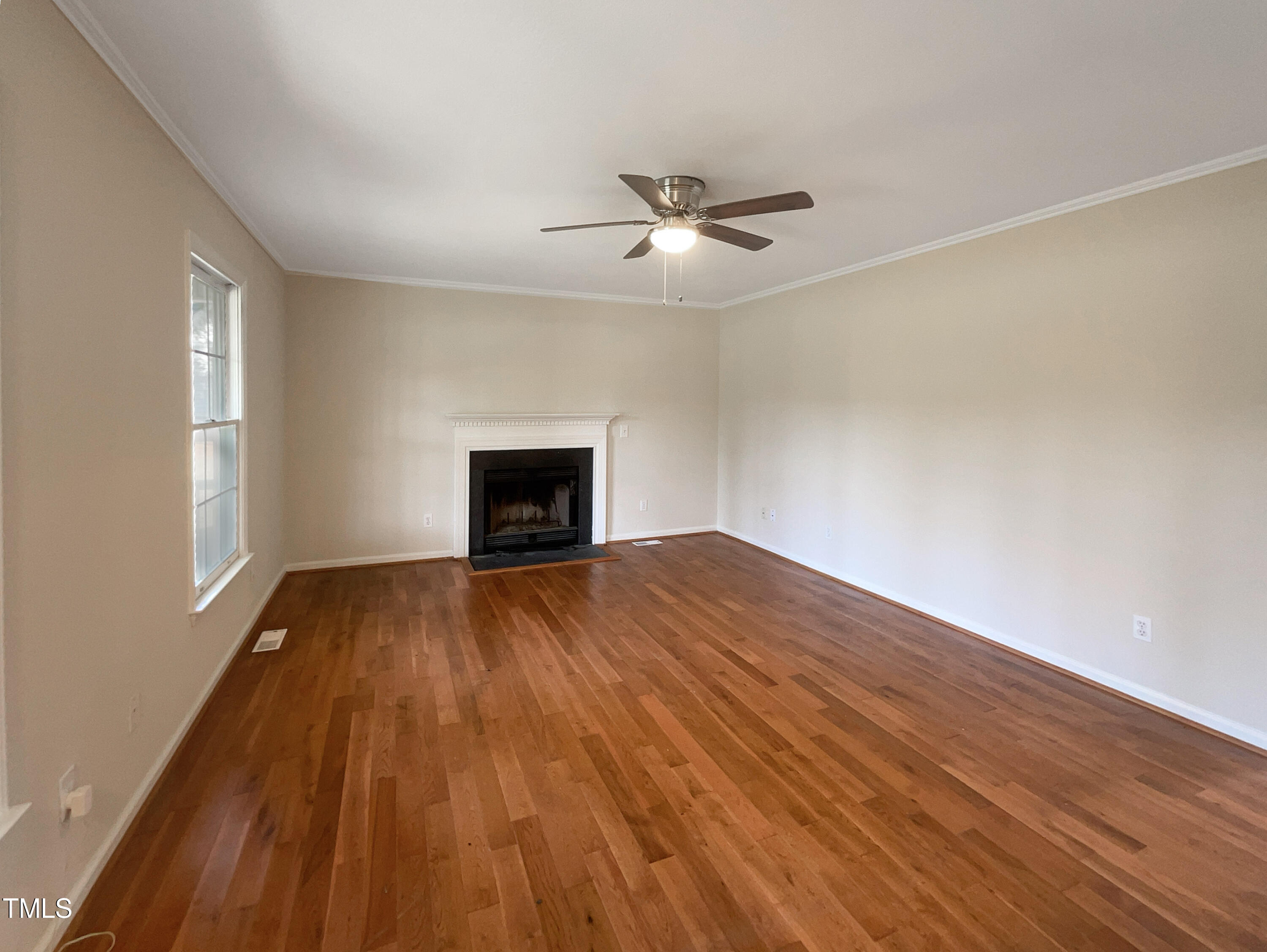 27 Pine Croft Road Angier, NC 27501 - Photo 3 of 19 an empty room with wooden floor fan and windows