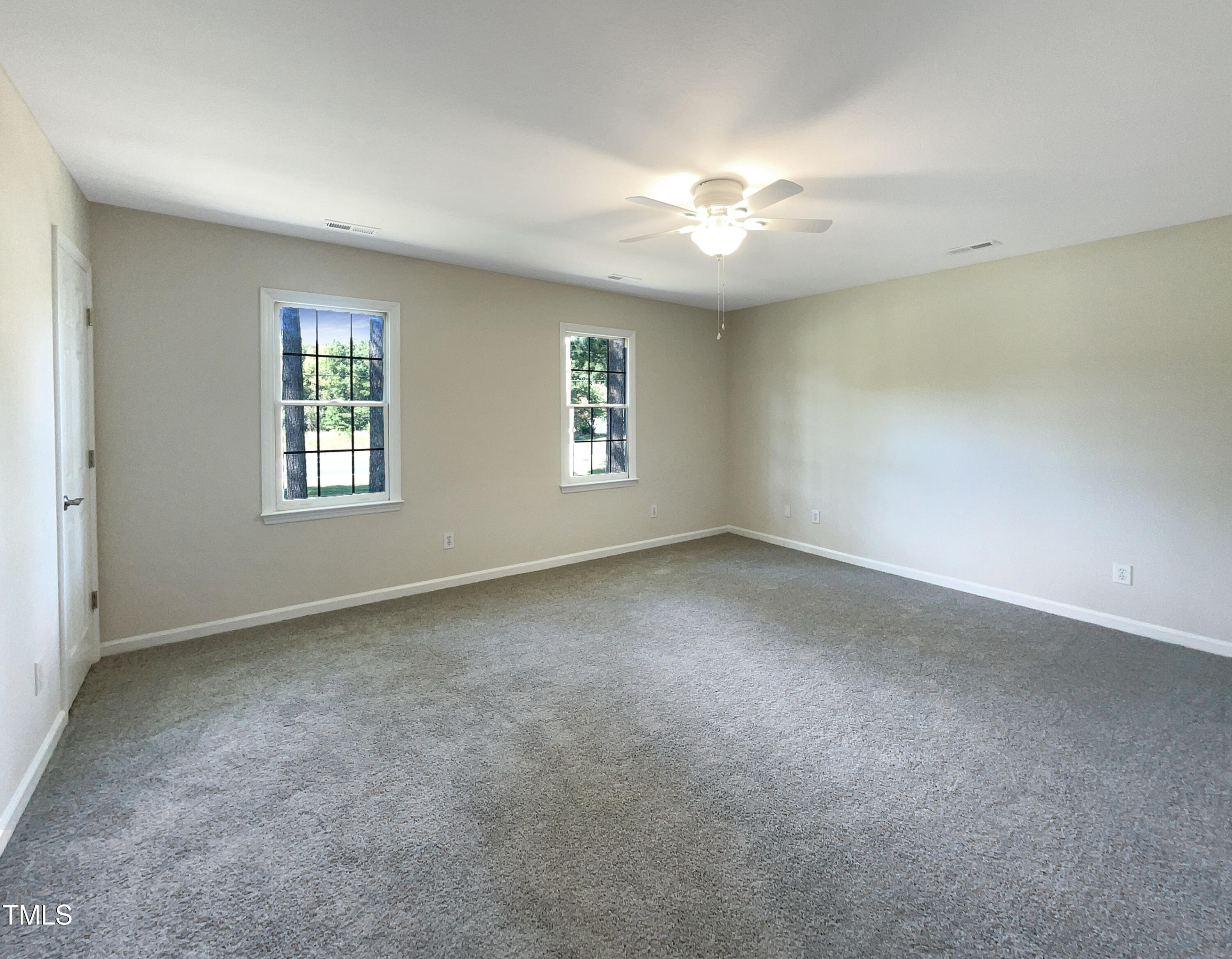 27 Pine Croft Road Angier, NC 27501 - Photo 5 of 19 an empty room with windows and chandelier fan