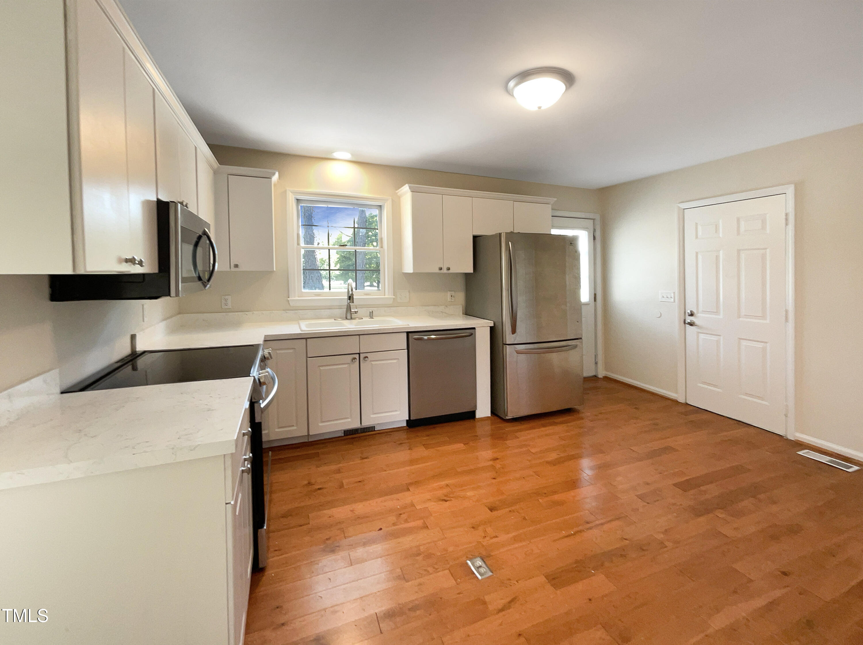 27 Pine Croft Road Angier, NC 27501 - Photo 6 of 19 a kitchen with stainless steel appliances granite countertop a refrigerator a stove and a sink