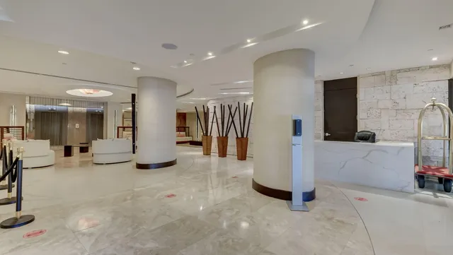 a living room with lots of furniture and a chandelier