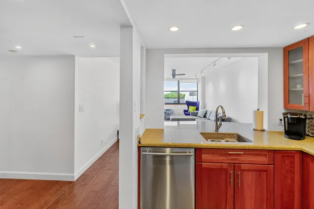 a kitchen with stainless steel appliances granite countertop a sink and cabinets