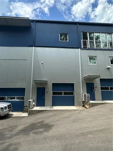 a view of a building with car parked