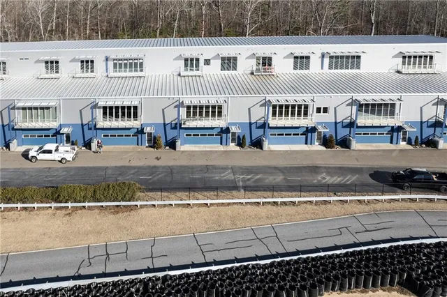 a front view of a building with glass top of a road