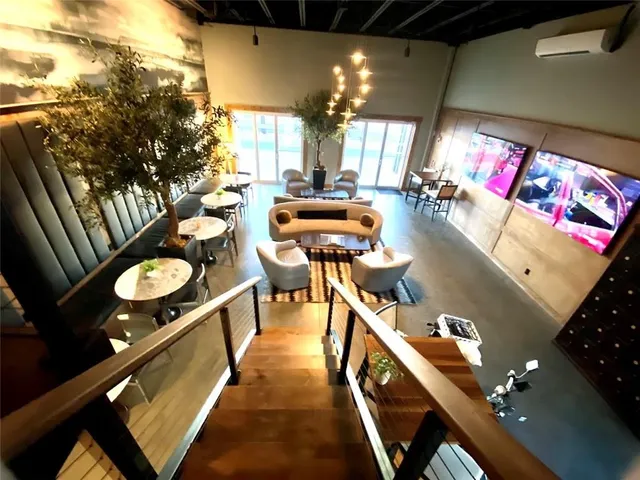 a balcony with chairs and a table