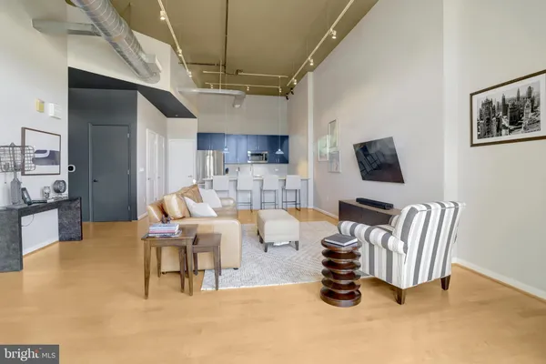 a living room with furniture and a kitchen