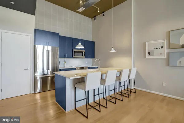 a kitchen with stainless steel appliances granite countertop a stove a sink refrigerator and microwave