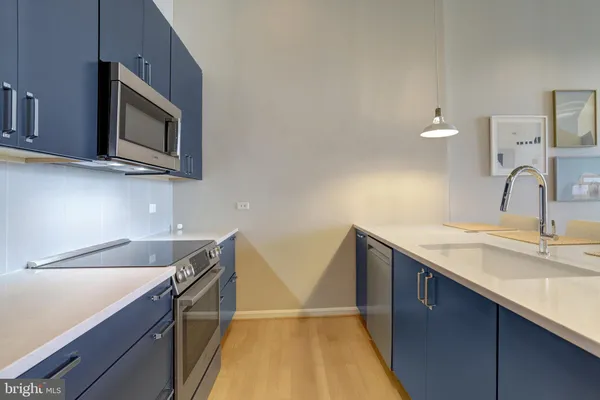 a kitchen with stainless steel appliances granite countertop a sink and a microwave