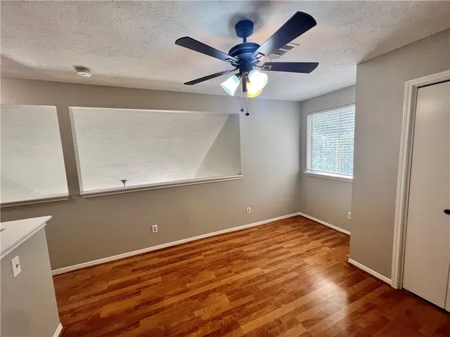 a view of room with wooden floor and fan