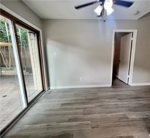 a view of a room with wooden floor and fan