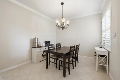 a view of a dining room with furniture and chandelier