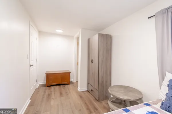 a view of room with wooden floor and bathroom