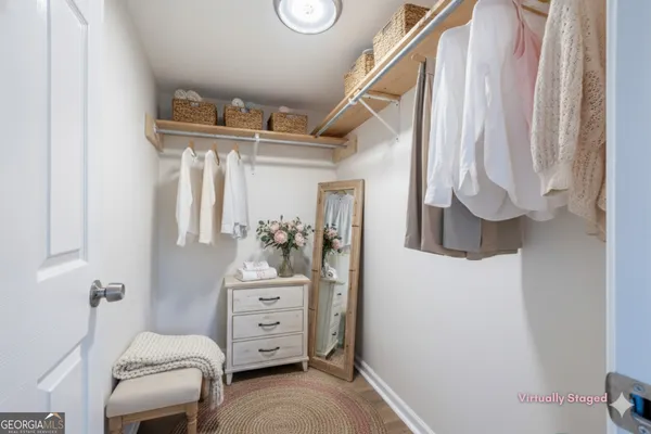 a bedroom with a baby bed a couch and dresser