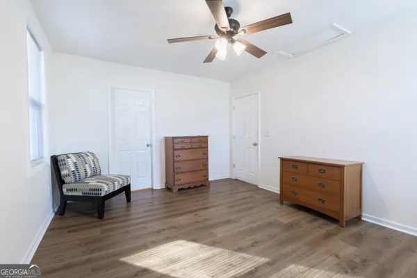 a living room with furniture and a ceiling fan