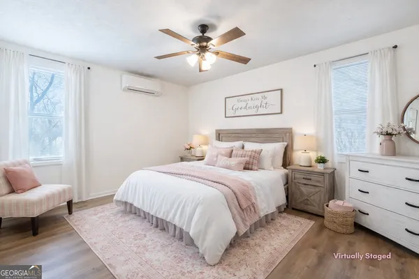 a bedroom with a large bed and a couch