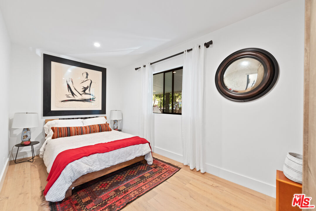 29500 Heathercliff Road, Unit 14 Malibu, CA 90265 - Photo 14 of 28 a bedroom with a bed and a painting on the wall