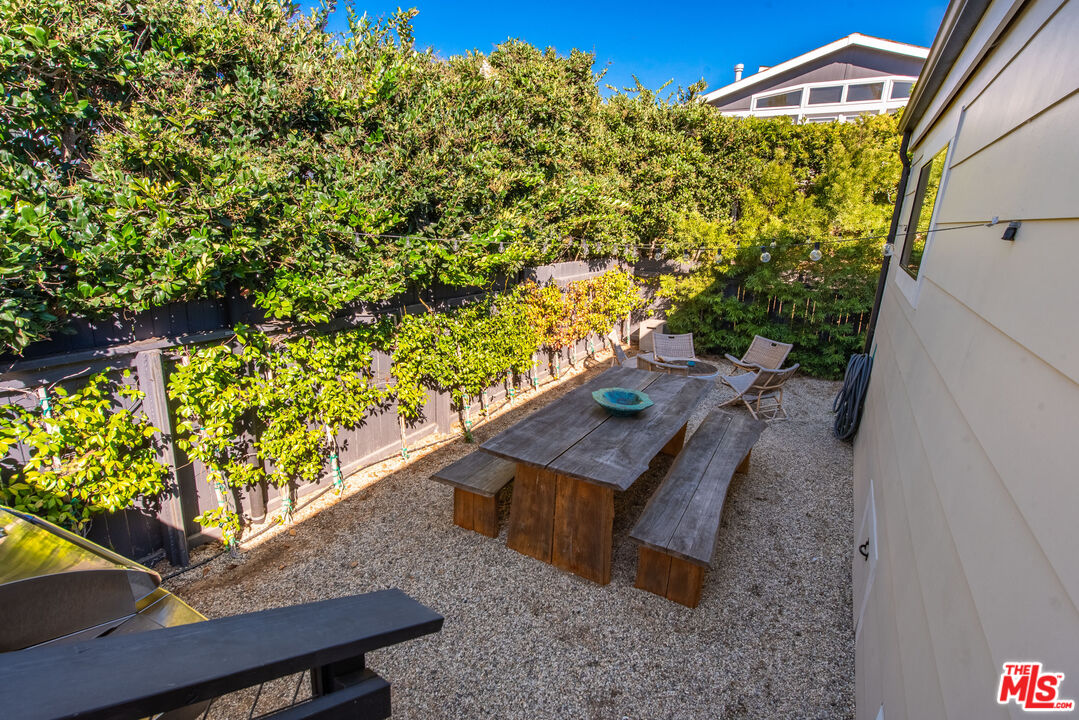 29500 Heathercliff Road, Unit 14 Malibu, CA 90265 - Photo 23 of 28 a wooden bench sitting in front of a building