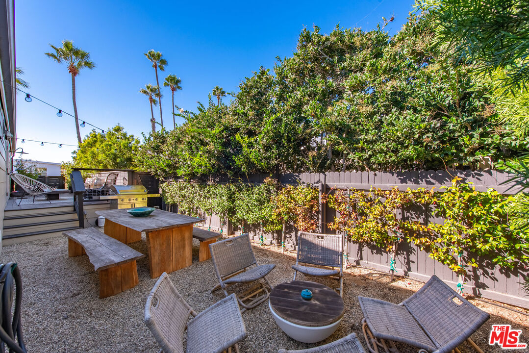 29500 Heathercliff Road, Unit 14 Malibu, CA 90265 - Photo 24 of 28 a view of a backyard with furniture and a fire pit