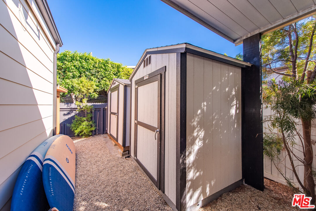 29500 Heathercliff Road, Unit 14 Malibu, CA 90265 - Photo 26 of 28 a view of a house with a large window and potted plants