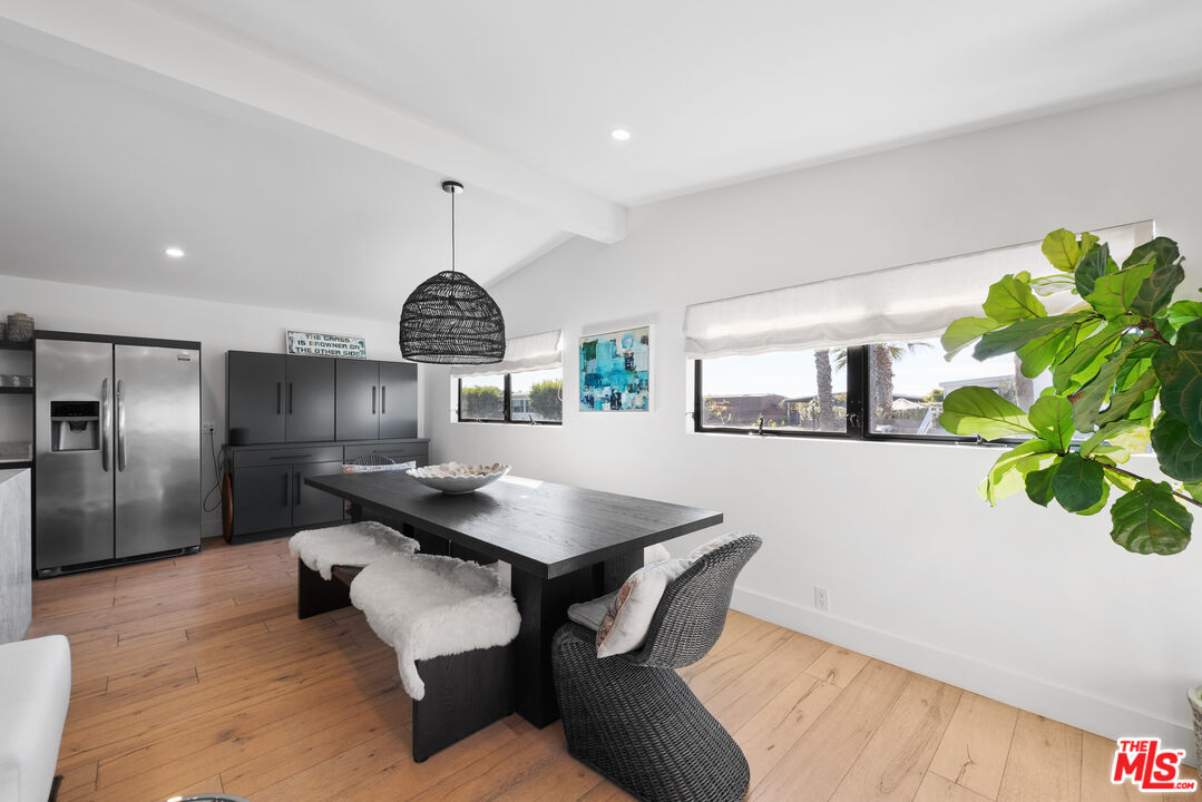 29500 Heathercliff Road, Unit 14 Malibu, CA 90265 - Photo 7 of 28 a dining room with furniture and a chandelier