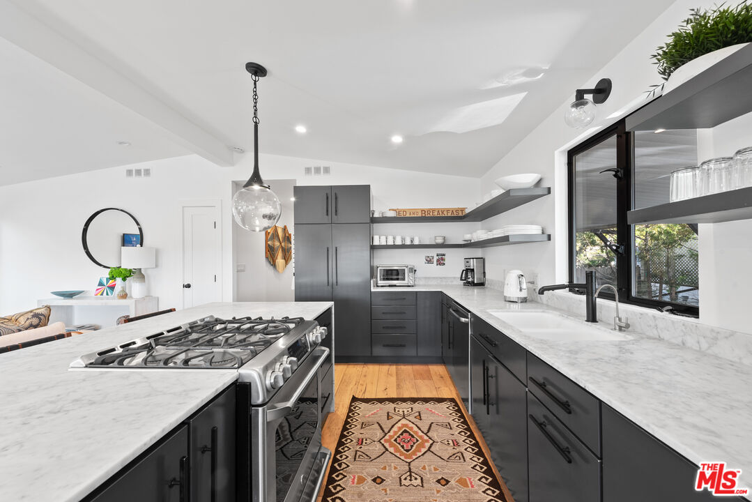 29500 Heathercliff Road, Unit 14 Malibu, CA 90265 - Photo 9 of 28 a kitchen with stove a sink and a refrigerator