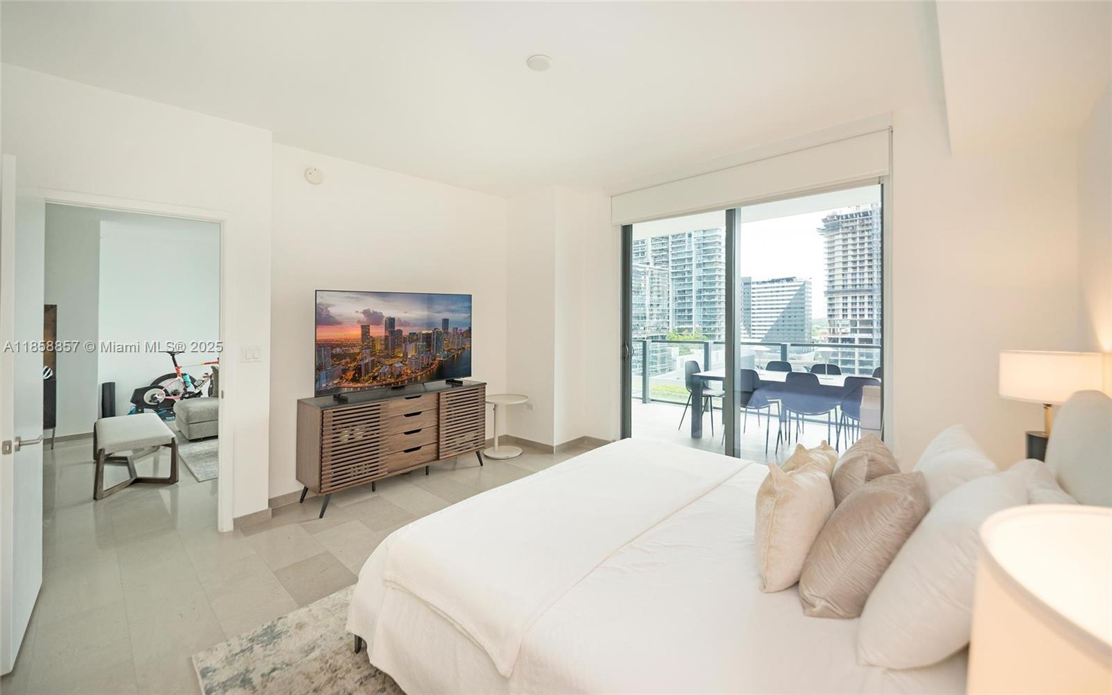 68 Southeast 6th Street, Unit 1008 Miami, FL 33131 - Photo 16 of 37 a bedroom with a bed and large windows