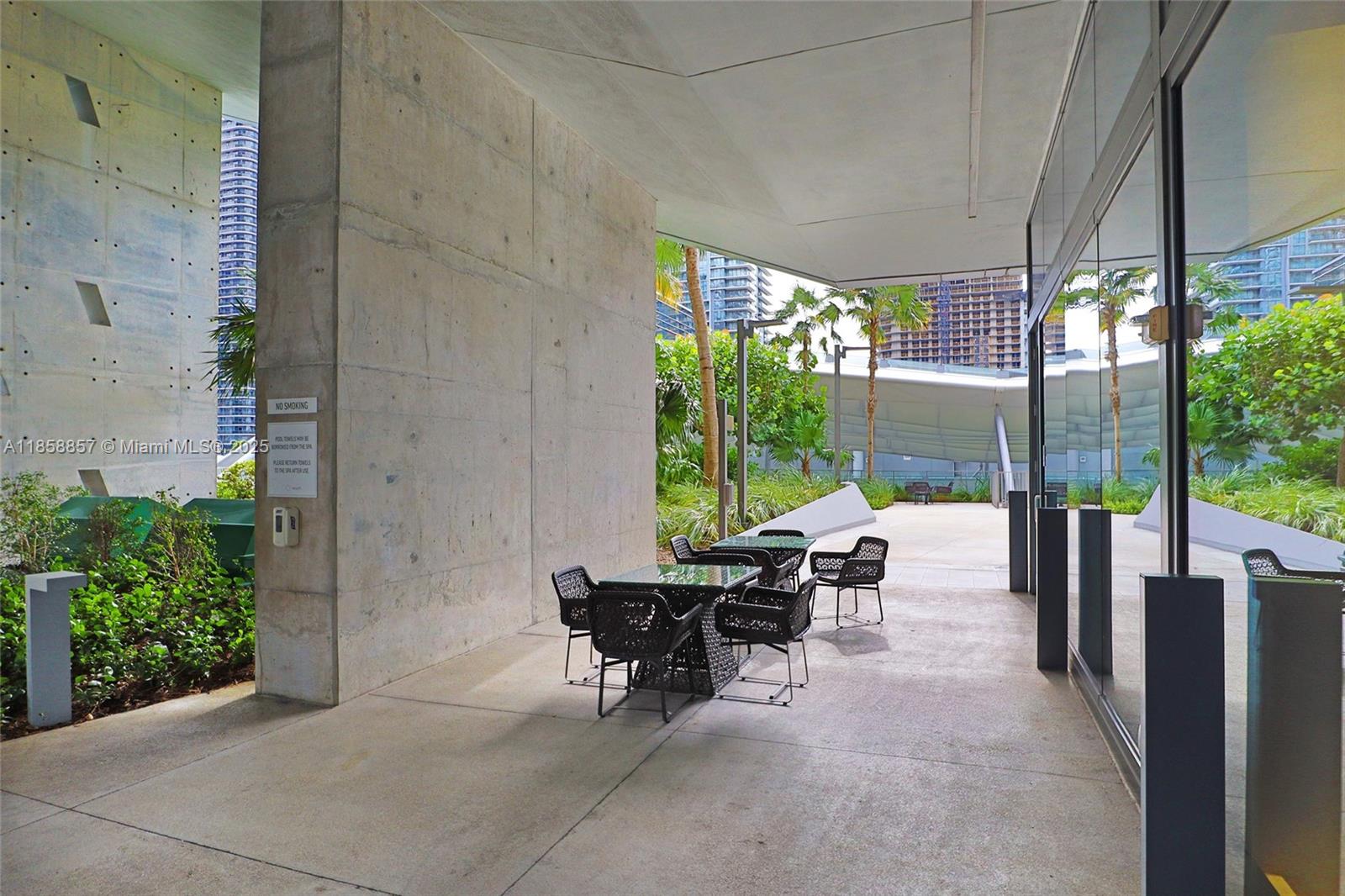 68 Southeast 6th Street, Unit 1008 Miami, FL 33131 - Photo 32 of 37 a building outdoor space with patio furniture and potted plants