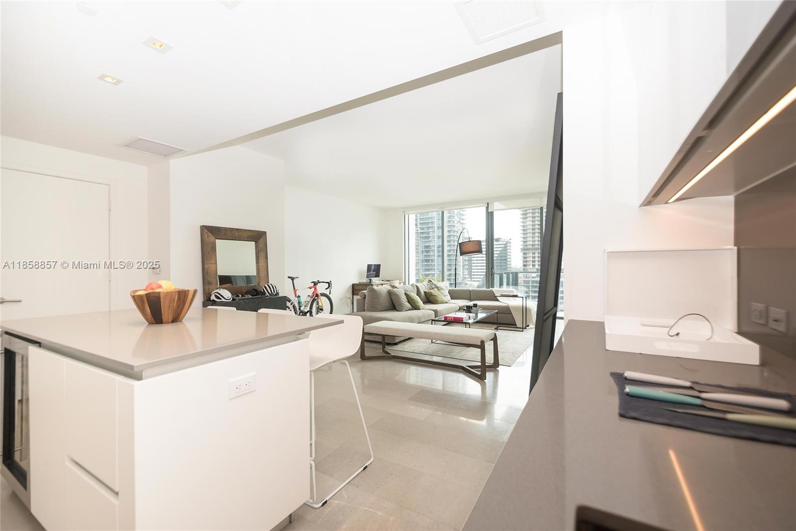 68 Southeast 6th Street, Unit 1008 Miami, FL 33131 - Photo 4 of 37 a view of living room with furniture and flat screen tv