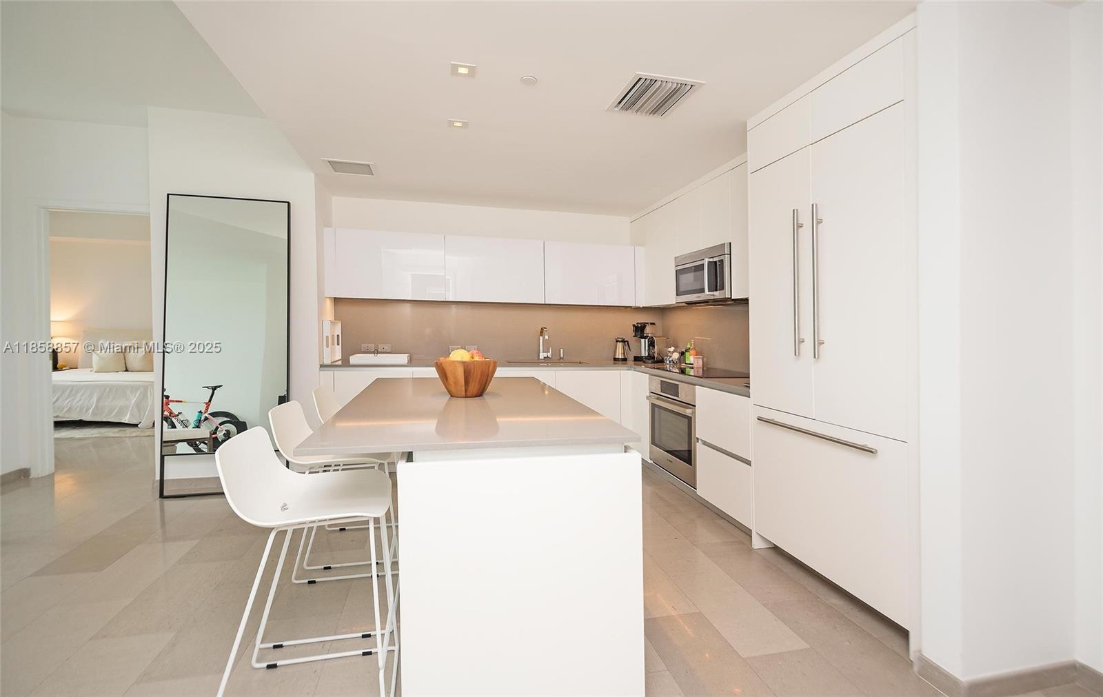 68 Southeast 6th Street, Unit 1008 Miami, FL 33131 - Photo 8 of 37 a kitchen with a sink a stove and chairs