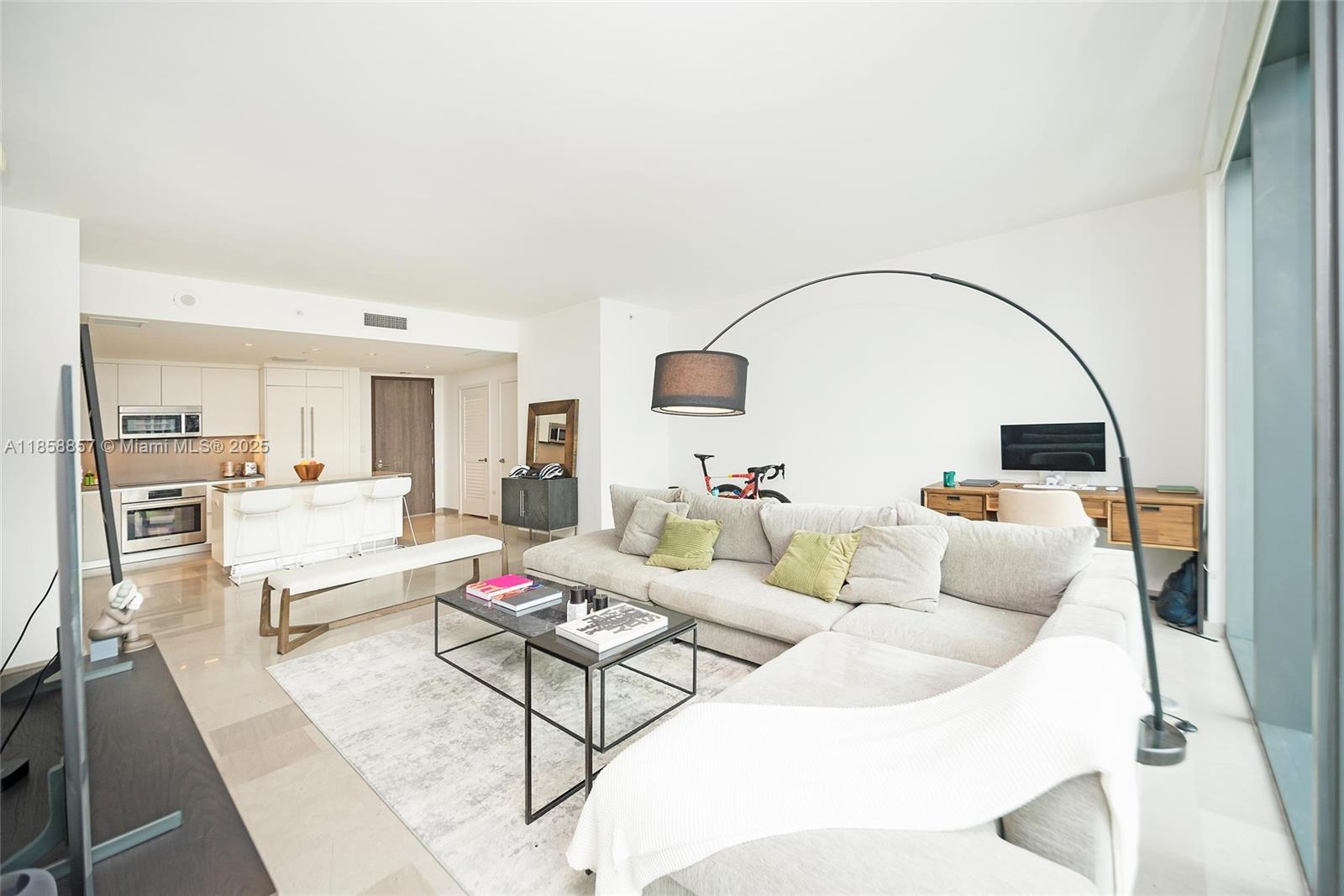 68 Southeast 6th Street, Unit 1008 Miami, FL 33131 - Photo 10 of 37 a living room with furniture and a flat screen tv