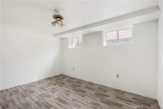 a view of a room with a window and a ceiling fan