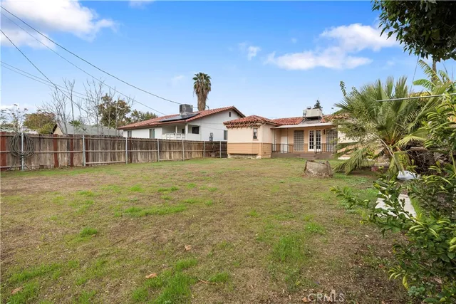 a view of a house with a big yard and garden