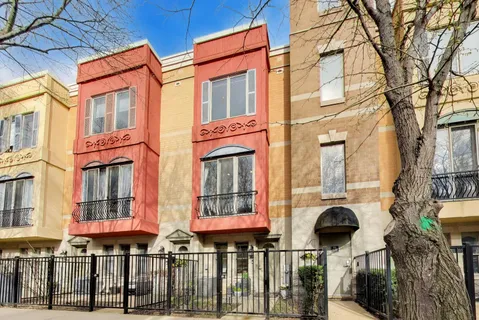 front view of a brick house with large windows