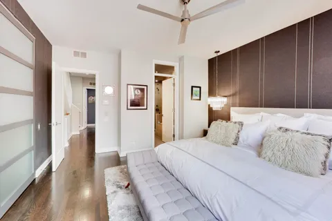a bedroom with a large bed and a chandelier