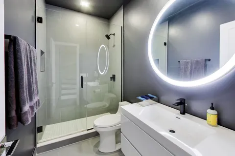 a bathroom with a sink a toilet and shower