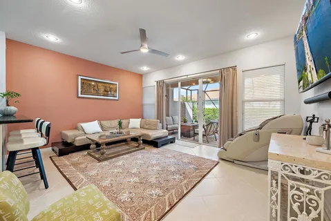 a living room with furniture a large window and a flat screen tv