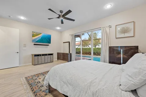 a spacious bathroom with a mirror a double vanity sink and a bathtub