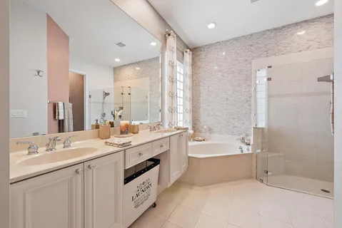 a bathroom with a bathtub shower sink and a shower