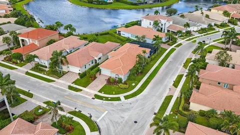 an aerial view of lake and residential houses with outdoor space
