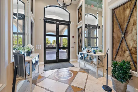 a dining room with furniture and a floor to ceiling window