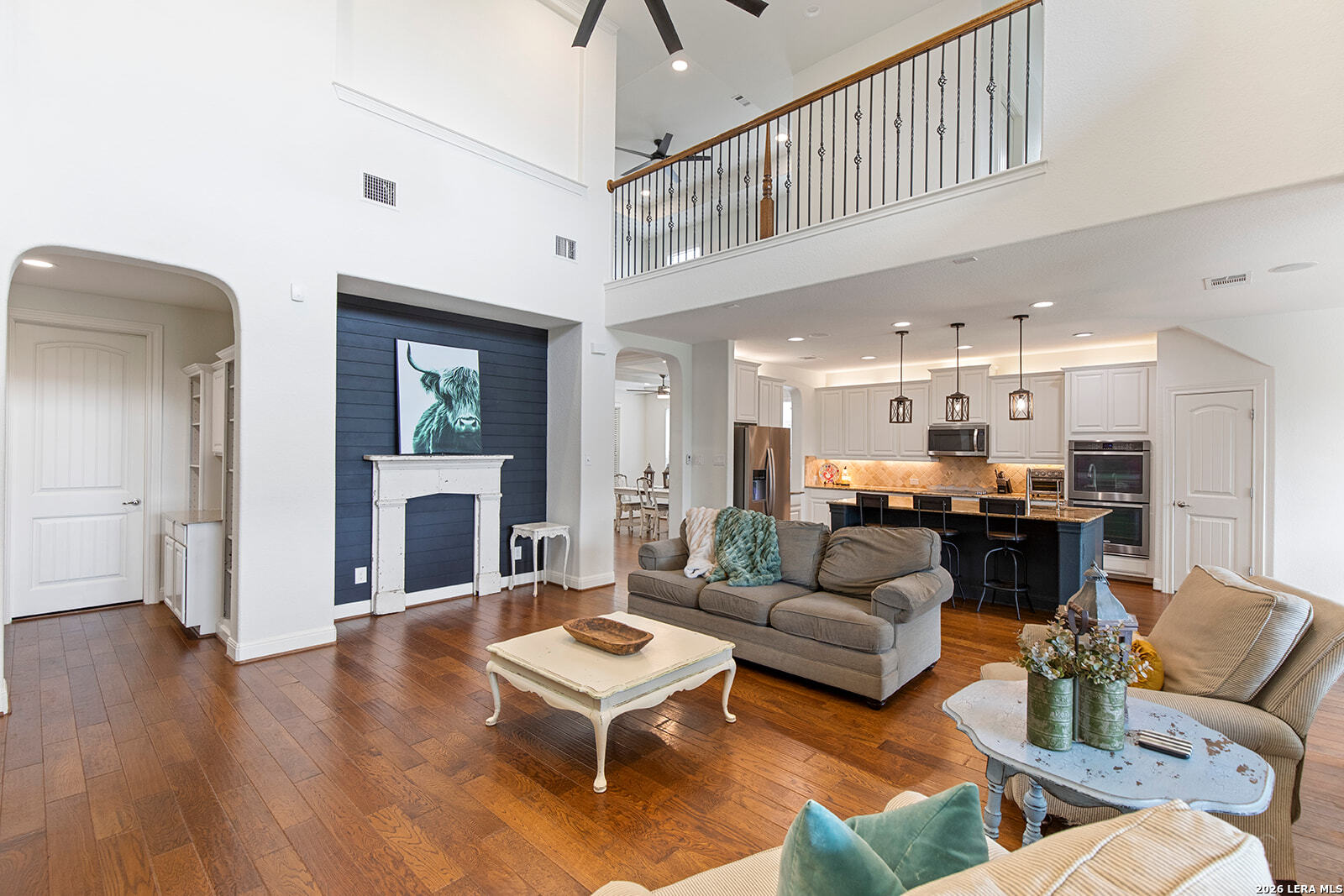 8039 Cibolo Valley Fair Oaks Ranch, TX 78015 - Photo 16 of 63 a living room with furniture a fireplace and a chandelier