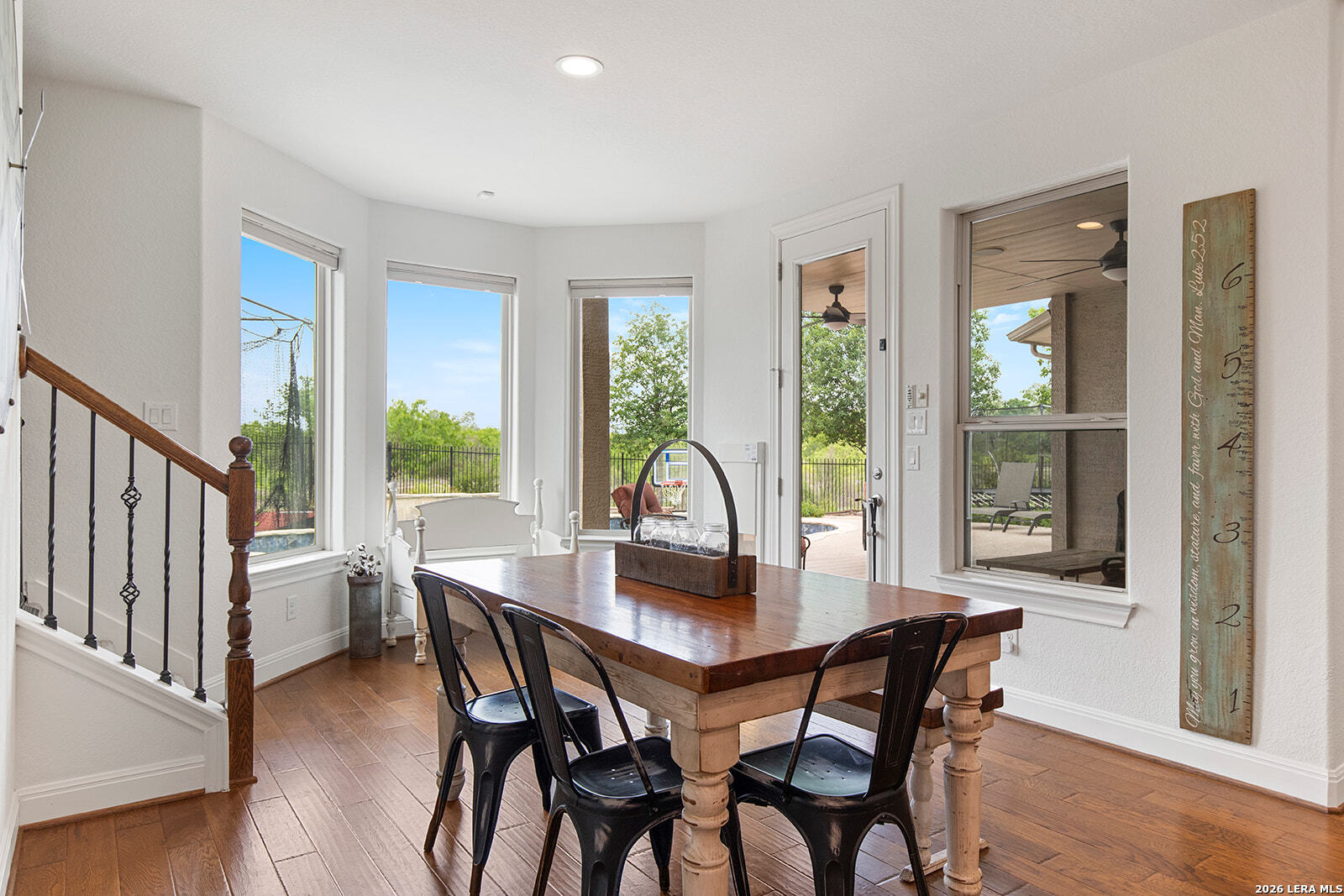 8039 Cibolo Valley Fair Oaks Ranch, TX 78015 - Photo 18 of 63 a view of a dining room with furniture window and wooden floor